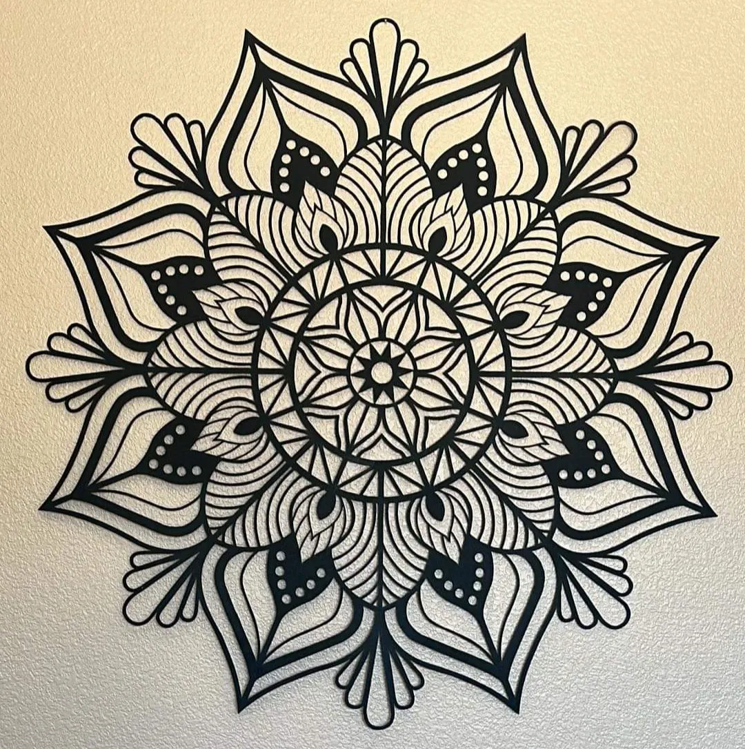 An intricate metal mandala wall art, a gift from staff, displayed in the office