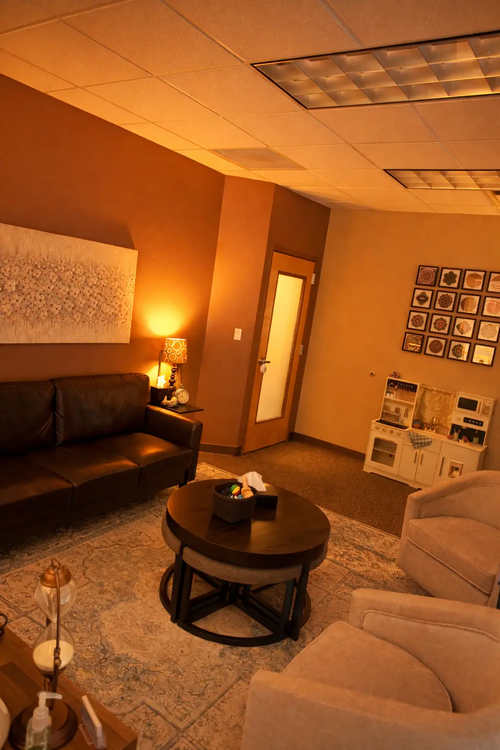 A welcoming office corner with warm lamplight and seating